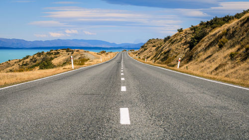 Road amidst mountains against sky