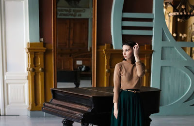 Young woman and piano in art deco interior