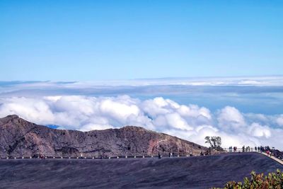 Scenic view of mountains against cloudy sky