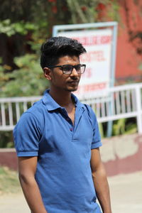 Young man wearing sunglasses standing outdoors