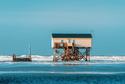 Pile dwelling on the beach of sankt peter-ording in germany.