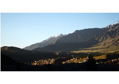 Illuminated mountains against clear sky