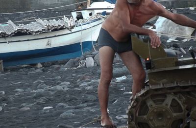 Full length of shirtless man in sea