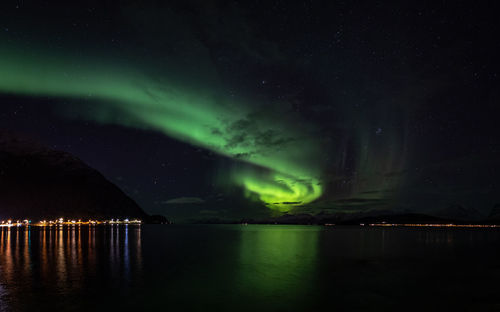 Scenic view of lake against sky at night