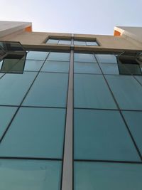 Low angle view of office building against sky