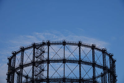 Low angle view of crane against blue sky