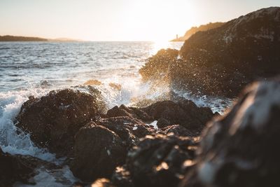 Scenic view of rocks in sea against sky