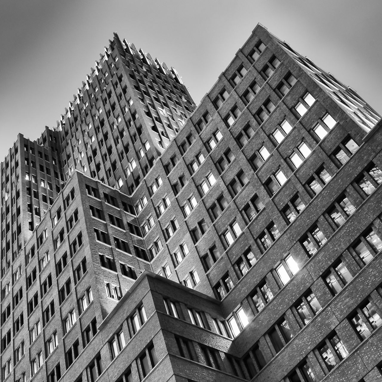 building exterior, architecture, built structure, low angle view, window, modern, city, office building, building, tall - high, skyscraper, clear sky, tower, sky, glass - material, day, outdoors, no people, residential building, tall