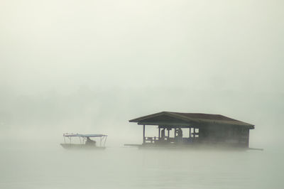 Lifeguard hut in lake against sky