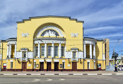 Low angle view of yellow building against sky