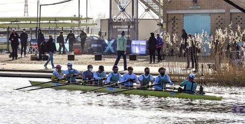 Group of people in boat against buildings