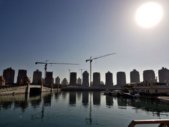 Buildings in city against clear sky