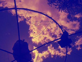 Low angle view of silhouette trees against sky at sunset
