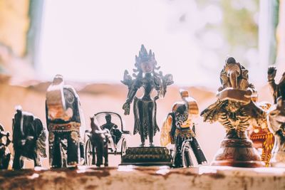 Statue on table against trees