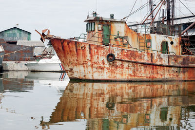 Old fishing boat in cinefuego. small port. rusty, distressed. calm day.