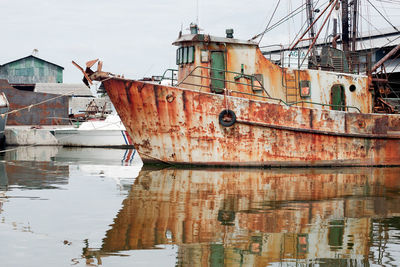 View of damaged boat moored in water