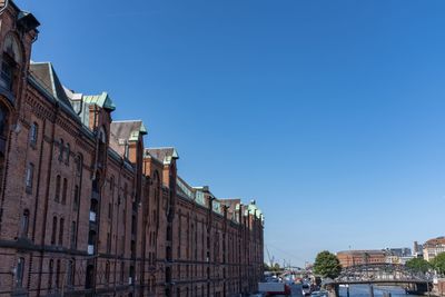 Low angle view of buildings against blue sky