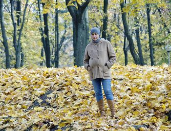 Rear view of woman standing in forest