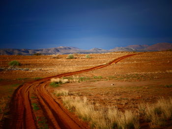 Dirt road along countryside landscape