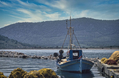 Sailboat on sea against sky in harbour 