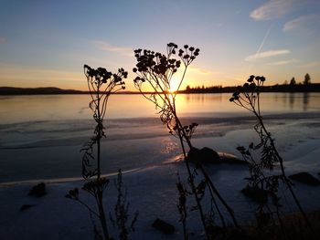 Scenic view of lake against sky at sunset