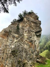 Low angle view of rock formation on mountain against sky