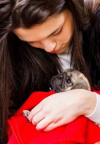 Close-up of young woman with pug