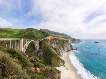 Scenic view of a bridge over a beach against sky
