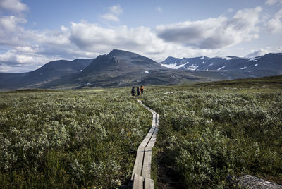 Scenic view of land and mountains against sky