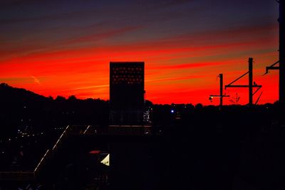 Silhouette of built structure against sky at sunset