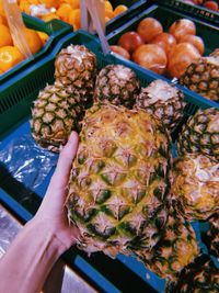 Close-up of hand holding fruits for sale in market