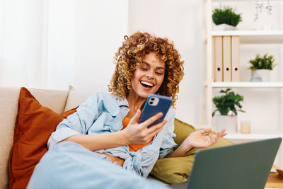 Young woman using laptop while sitting at home