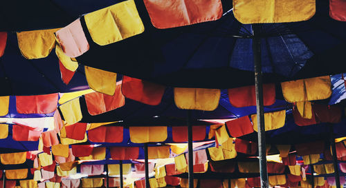Full frame shot of multi colored umbrellas hanging at market