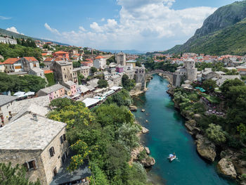 High angle view of townscape by sea against sky