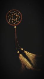 Close-up of illuminated lamp over black background