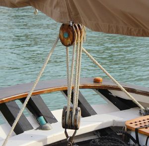 Close-up of rope tied to boat moored in sea