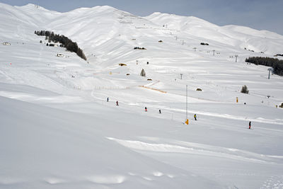 A ski teacher and kids learning skiing in the ski piste in the alps switzerland