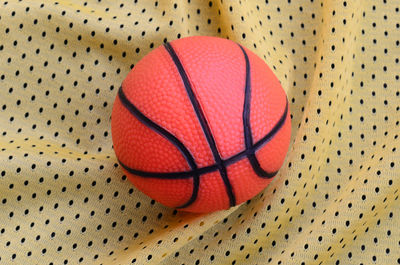 Directly above shot of basketball on patterned fabric