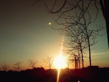 Low angle view of silhouette bare trees against sky during sunset