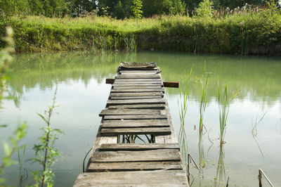 Wooden bench by lake