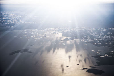 Aerial view of sea against sky on sunny day