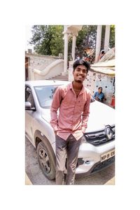 Portrait of man standing in car