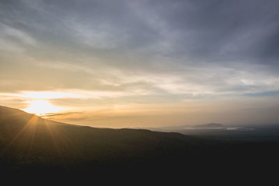 Scenic view of silhouette mountains against sky during sunset