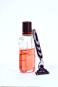 Close-up of drink on table against white background