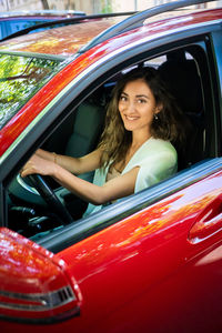 Portrait of young woman in car