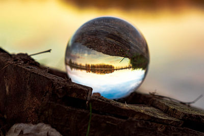 Upside down image of crystal ball on wood