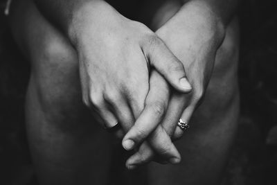 Midsection of couple holding hands