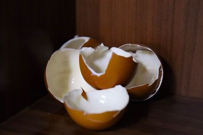 Close-up of broken egg on table