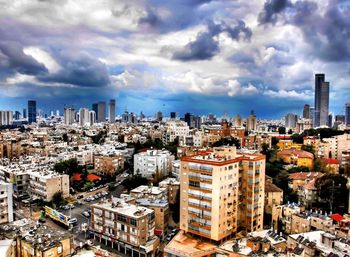 Cityscape against cloudy sky