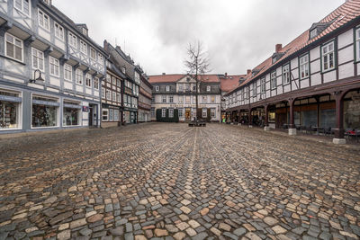 Street amidst buildings in city against sky